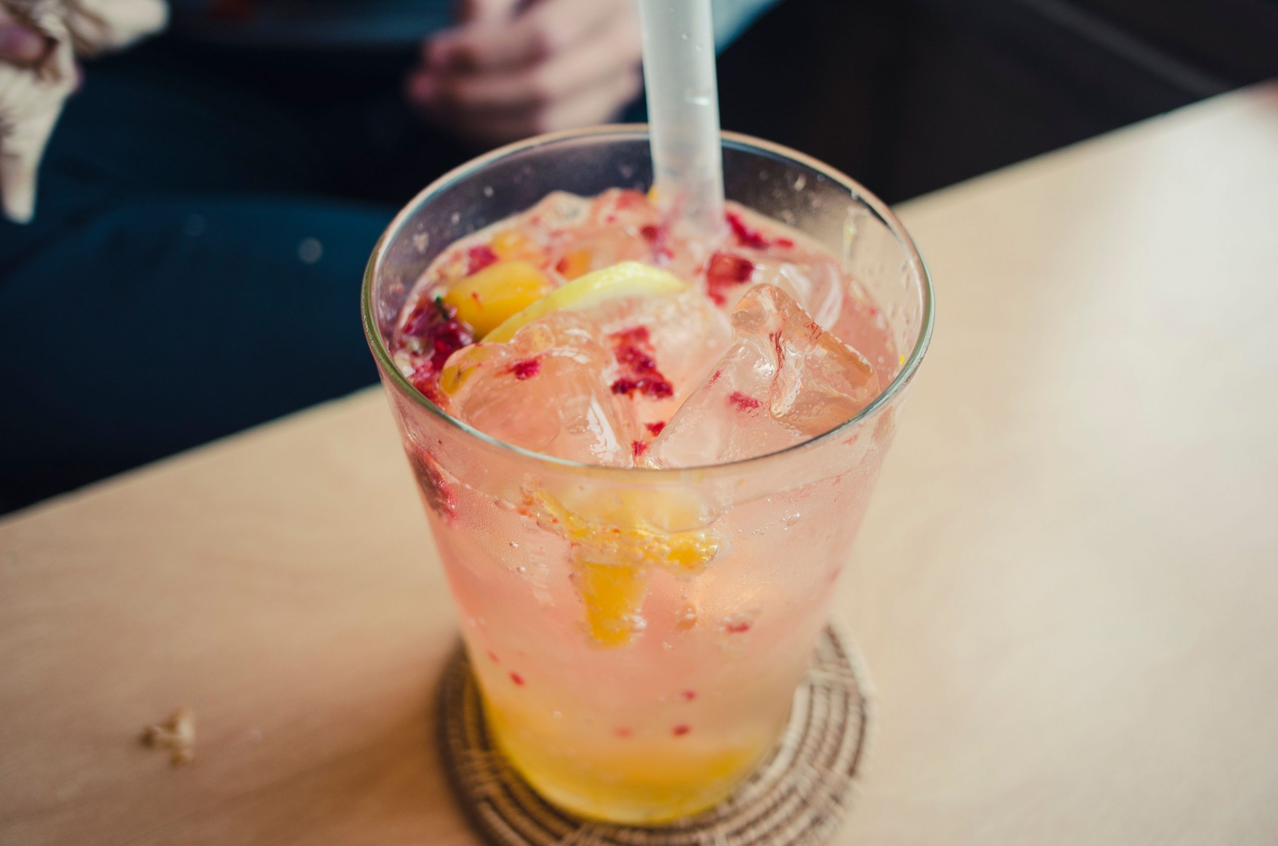 A close-up of a refreshing citrus berry iced beverage on a table, perfect for summer.